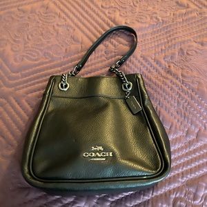 Gently used Coach bag with a rocker edge.